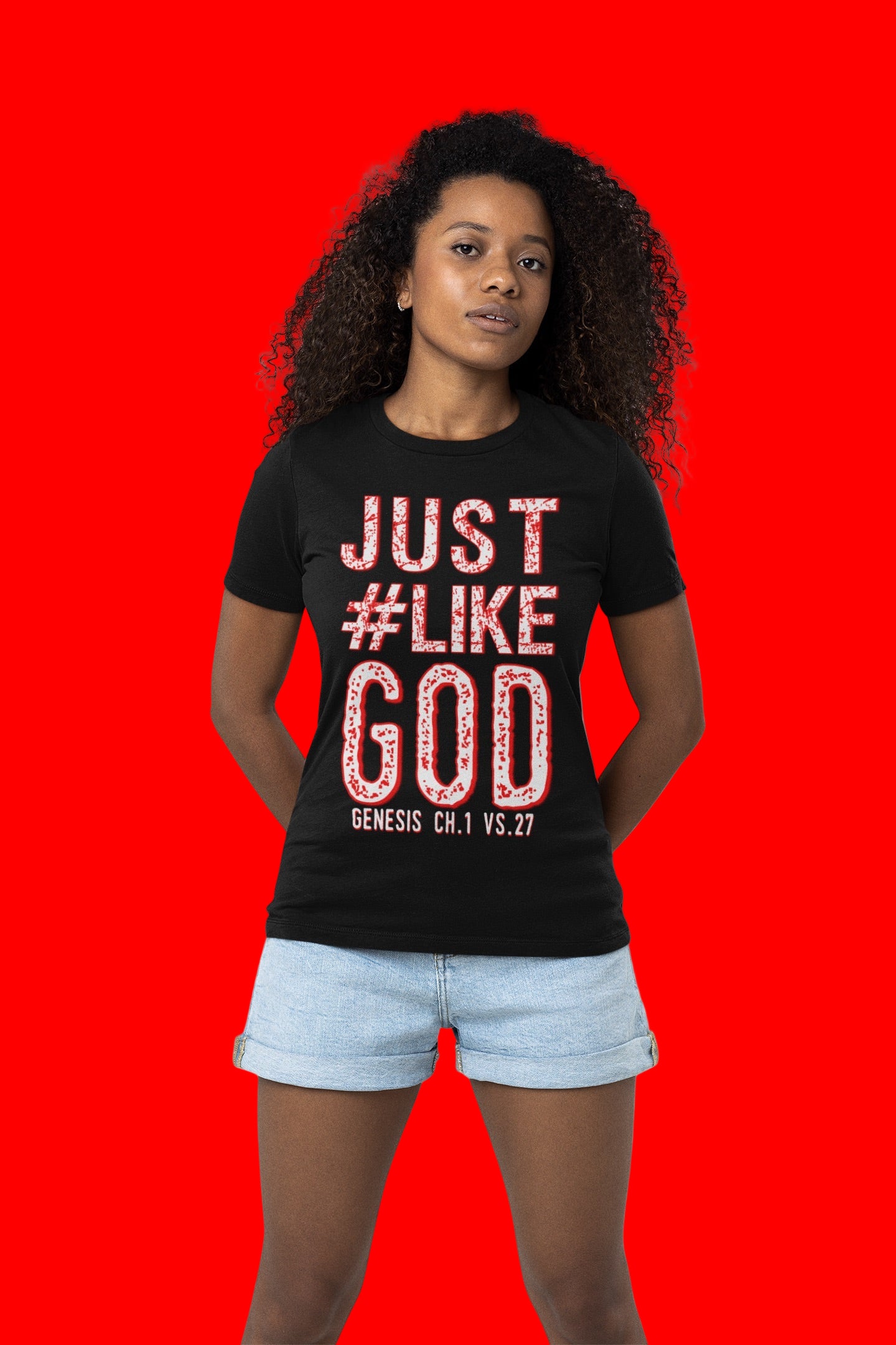Woman wearing a black t-shirt depicting the following Bible verse "Genesis 1:27 in red text on a red background