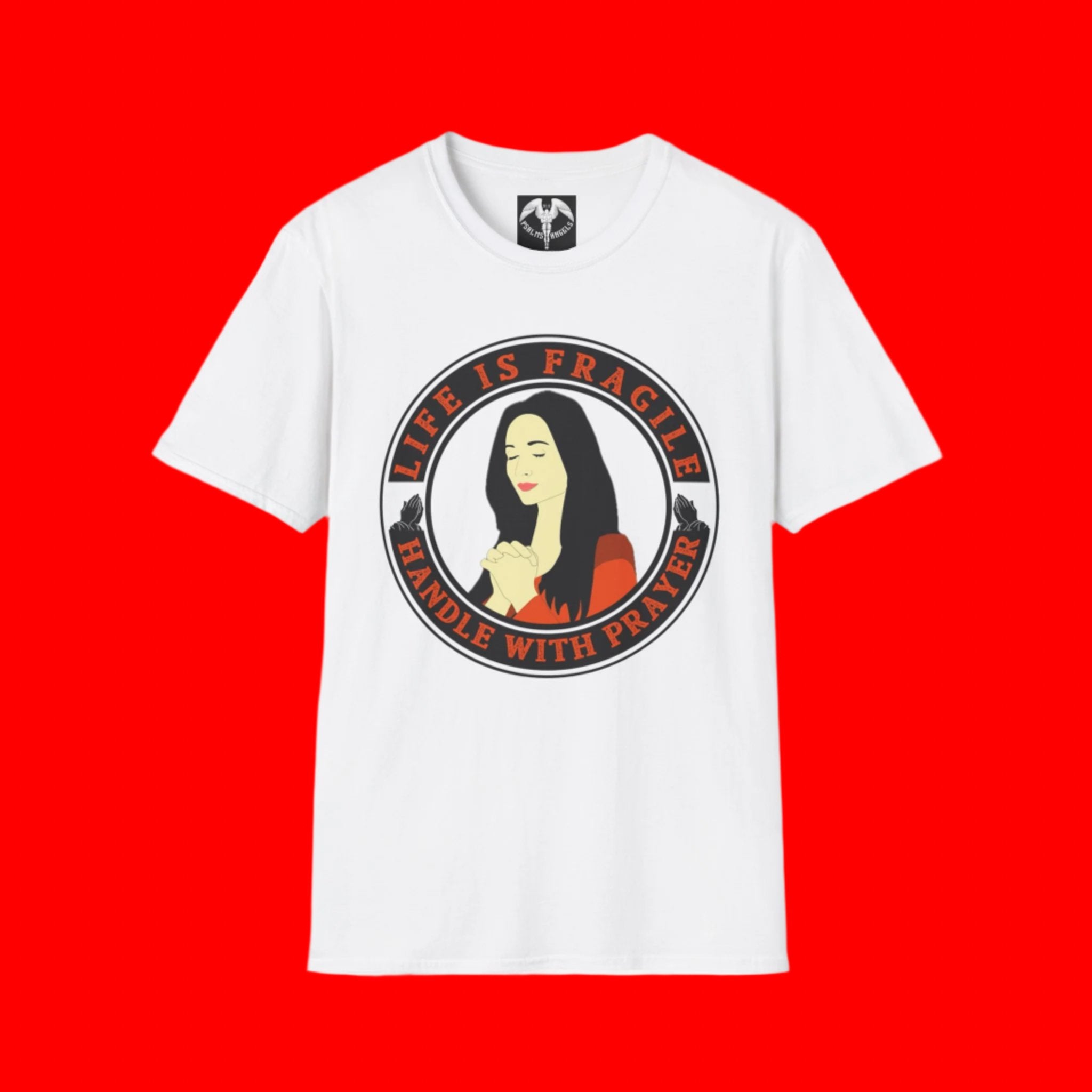 Printed on a white psalms angels T-shirt we have the phrase life is fragile handle with prayer