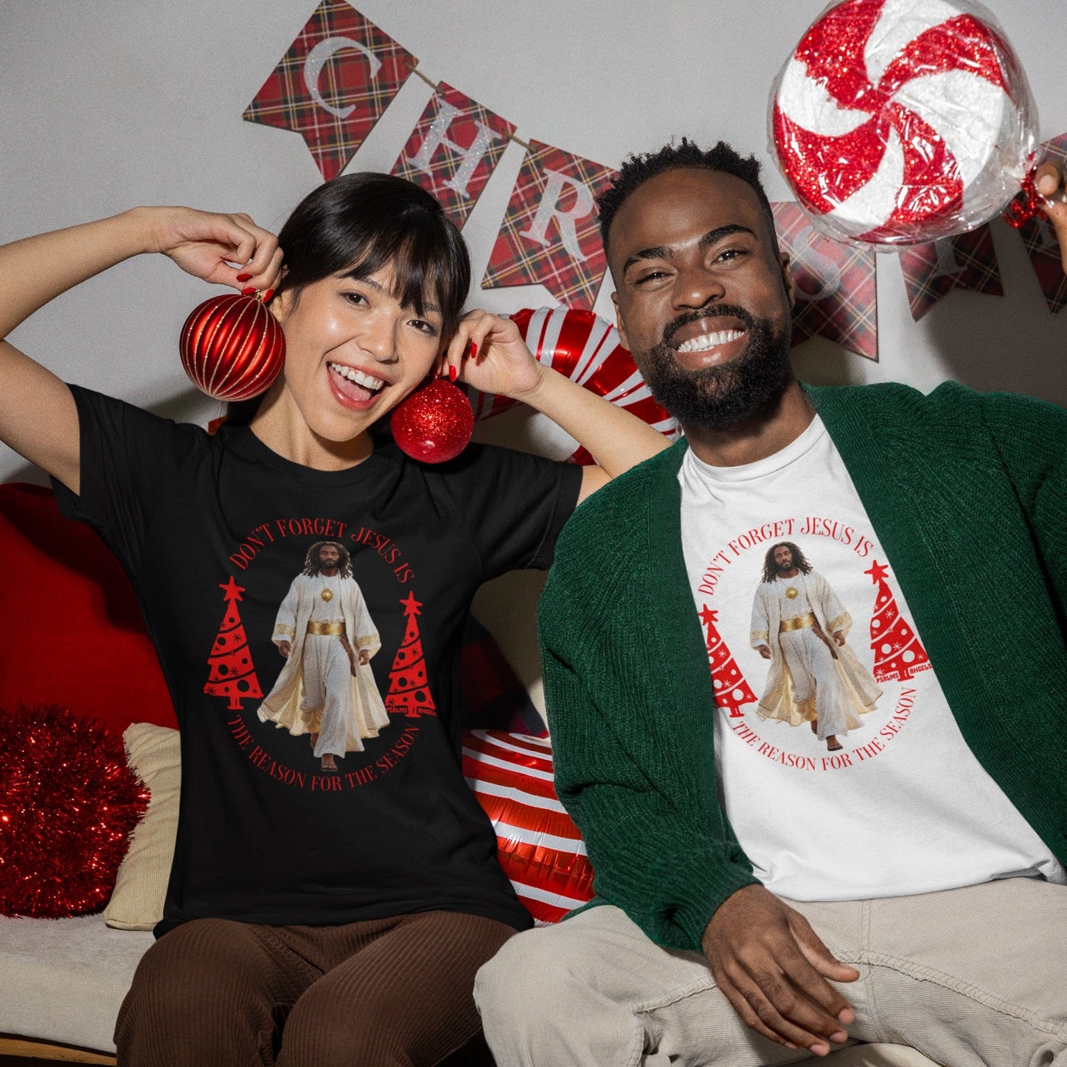Two people sitting together wearing Jesus is the reason for the season Christmas-themed T-shirts and holding candy canes.