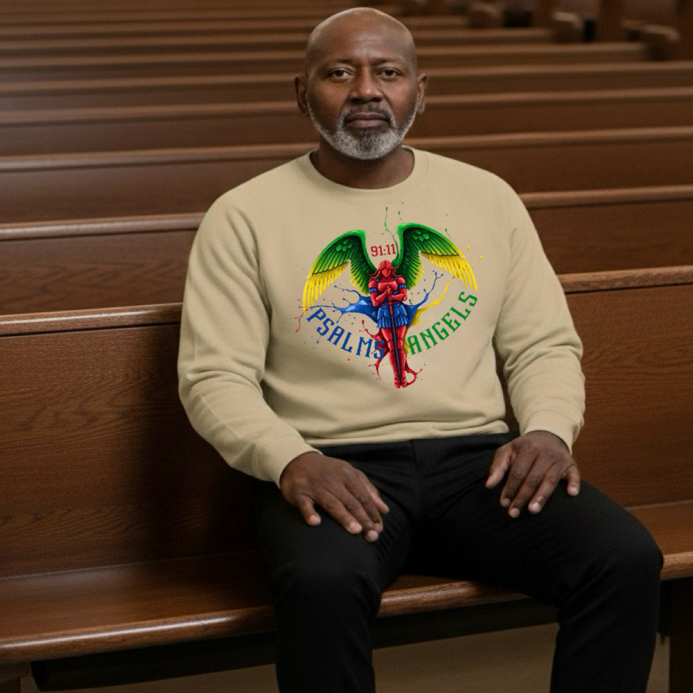 Man sitting on a wooden pew wearing a beige sweatshirt with colourful Psalms Angels graphic design.